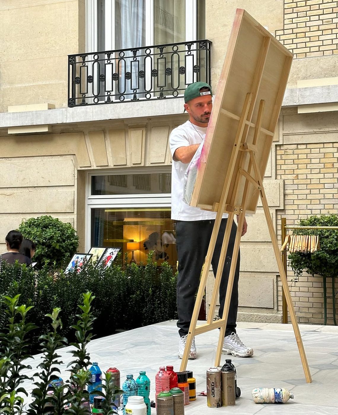 Zoulli Art painting a canvas live on his easel at an event
